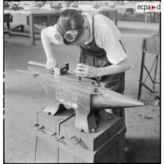 Un ouvrier de l'atelier de réparation de l'armée de l'Air (ARAA) travaille une pièce de métal sur l'aérodrome de Toulouse.