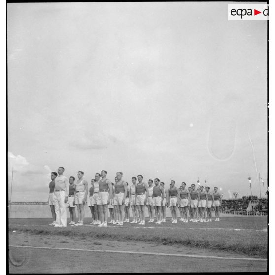 Des athlètes pendant la montée des couleurs avant les compétitions d'un championnat sportif militaire sur un stade à Clermont-Ferrand.