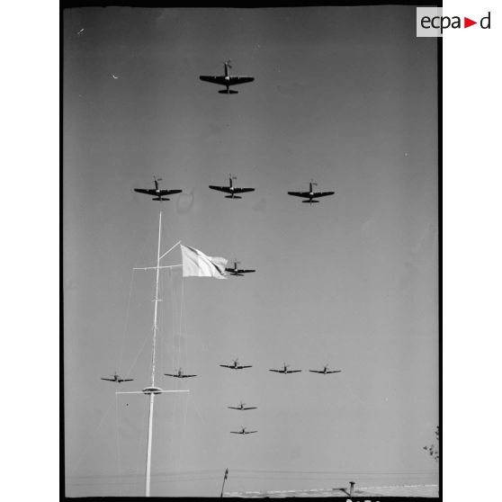 Des avions de chasse Bell P-63 Kingcobra de la 5e escadre de chasse volent en formation de croix de Lorraine au-dessus de Salon-de-Provence.