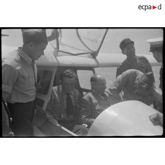 Lors de sa  visite du centre de vol à voile (sans moteur) du djebel Diss, Fernand Grenier, commissaire à l'Air, monte dans un planeur.