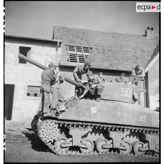 Maintenance sur le canon de 76 mm du Sherman M4 A3 Flandres II du 3e escadron du 12e régiment de chasseurs d'Afrique (12e RCA).