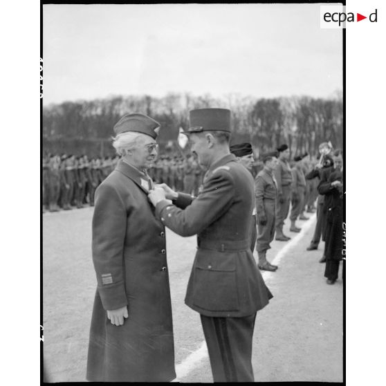 Le commandant Florence Conrad, commandant le groupe d'ambulancières Rochambeau, est décorée de la Légion d'honneur par le général Leclerc.
