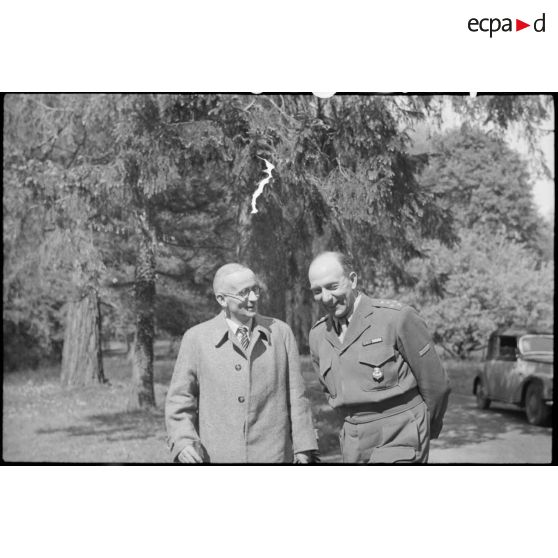 Le général d'armée Jean de Lattre de Tassigny en discussion avec une personnalité non identifiée.