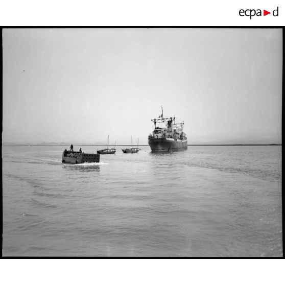 Débarquement d' un détachement de la 9ème Division d' Infanterie Coloniale (D.I.C.) d' un Landing Craft Matériel (L.C.M.