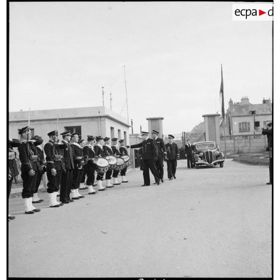 Le vice-amiral d'escadre Jules Le Bigot, préfet maritime, arrive sur la base d'aéronautique navale de Cherbourg où il passe en revue un piquet d'honneur.