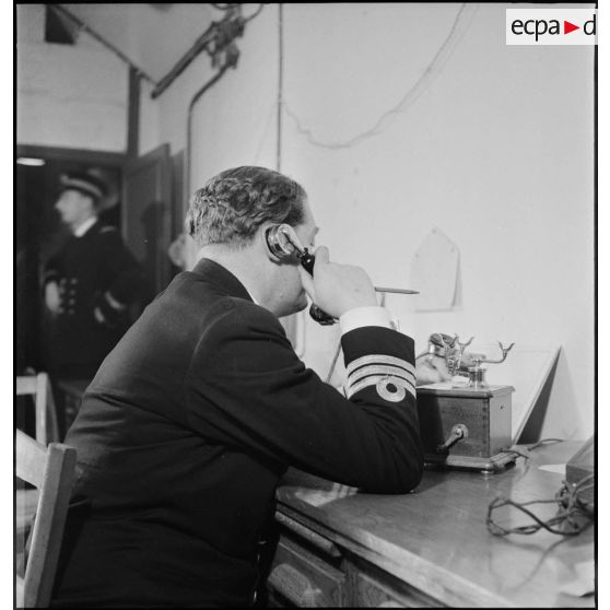 Un commander de la Royal Navy est au téléphone dans le poste de commandement (bastion 32) de l'amiral Abrial à Dunkerque.