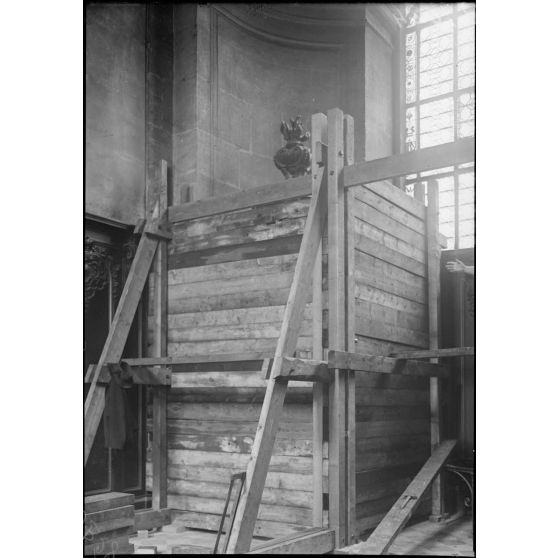 Paris, travaux de protection des oeuvres d'art. Eglise Saint-Sulpice (protection d'un confessionnal en bois sculpté du XVIIIe siècle). [légende d'origine]
