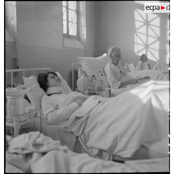 Des blessés, victimes civiles d'un bombardement allemand, sont alités dans un hôpital.