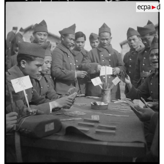 Des tirailleurs indochinois jouent à un jeu de société dans le centre de transition et de repos de Fréjus, baptisé "Camps du sud-est".