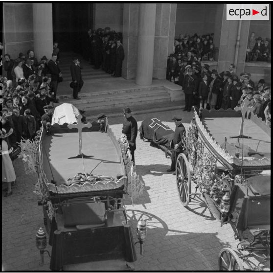 Plan général des obsèques des victimes d'un bombardement. La foule entoure les corbillards.