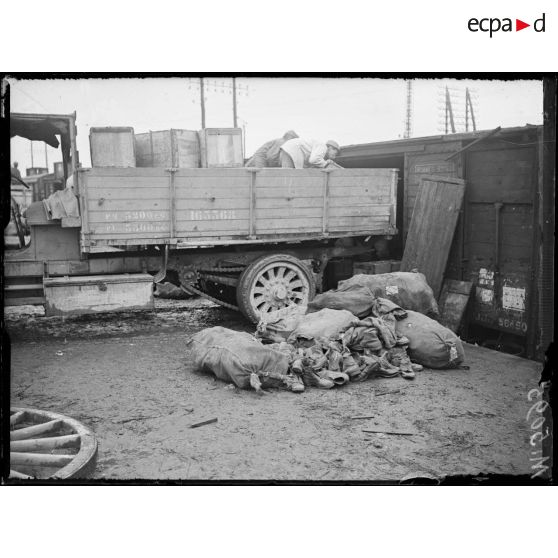 Orléans, aux magasins d'artillerie. Centre de récupération. Débarquement de caisses de vieux effets et matériels d'un wagon. [légende d'origine]