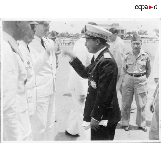 A son arrivée à l'aéroport de Tan Son Nhut, Norodom Sihanouk, le roi du Cambodge, discute avec les représentants de l'autorité civile et militaire venus l'accueillir.