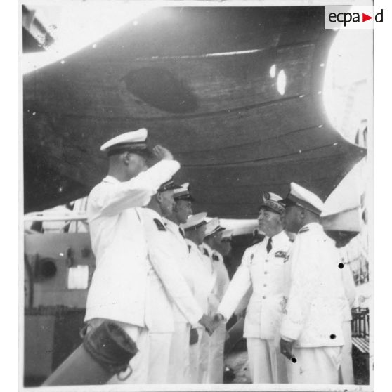 Dans le port de Saigon, lors d'une visite aux avisos "Le Chevreuil" et  "La Gazelle" et à la frégate "Le Tonkinois" , l'amiral Thierry d'Argenlieu salue des officiers superieurs. [description provisoire]