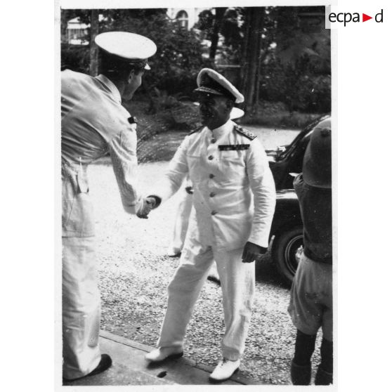 Lors de sa réception au palais du président Thinh, l'amiral britannique Archer est accueilli par le président du Gouvernement provisoire de la Cochinchine, Nguyen Van Thinh et par un représentant de l'autorité française. [description provisoire]