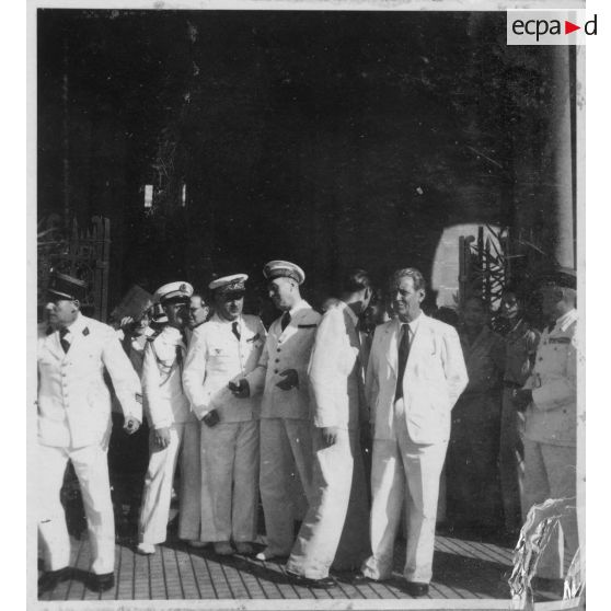 Lors d'une célébration en mémoire des morts pour la libération de la Cochinchine, après avoir assisté à une messe à la cathédrale Notre-Dame-de-Saigon, l'amiral Thierry d'Argenlieu, le président Nguyen Van Thinh,  Jean Cédile, et les représentants de l'autorité civile et militaire, sortent de la cathédrale. [description provisoire]