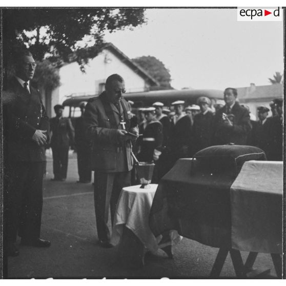 Alger. Hôpital Maillot. L'aumônier militaire se recueille devant le corps du défunt.