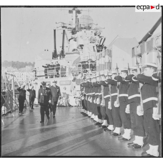 Alger. Une haie d'honneur présente les armes à l'amiral Barthélémy à bord du croiseur De Grasse (C610).