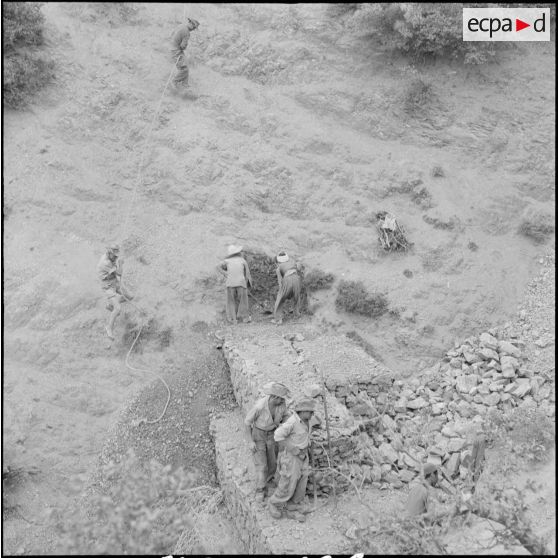 Ouvriers algériens travaillant sur le chantier d'une route entre Kerrata et Abkou.