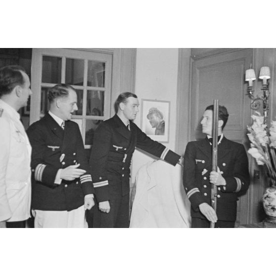 A Saint-Nazaire, une cérémonie non officielle lors de laquelle le commandant du sous-marin U-552, Erich Topp, et ses deux lieutenants, offrent un cadeau au reporter Heinrich Schwich.