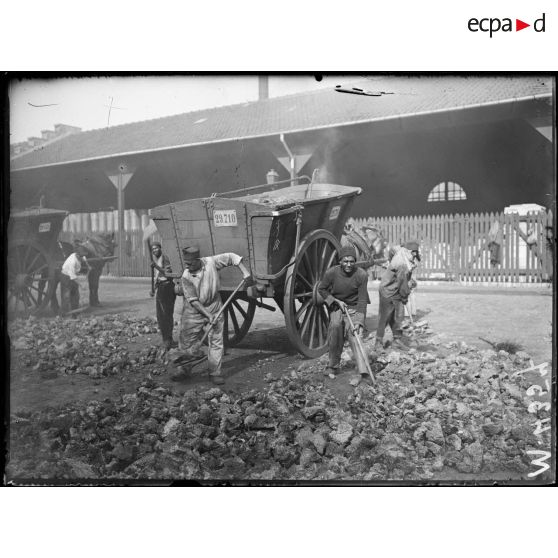 Usine à gaz à Clichy. Après son séchage à l'air, le coke est vendu aux particuliers. [légende d'origine]
