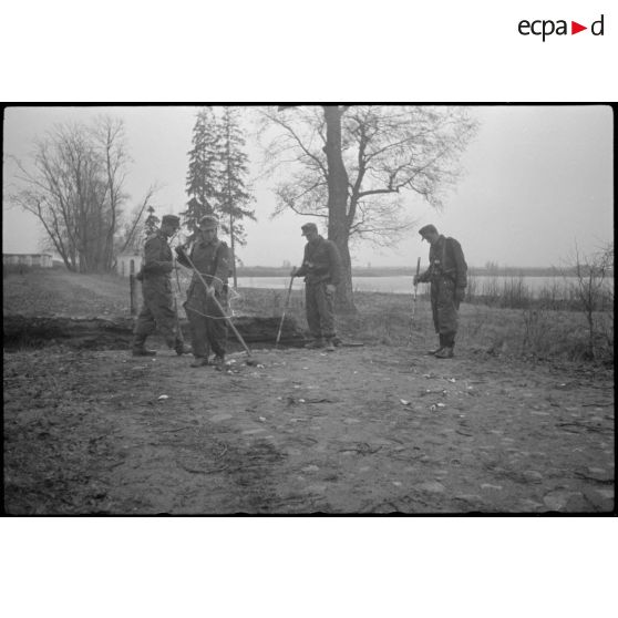 Des fantassins ou des pionniers fouillent le sol  à l'aide de détecteur de mines (Minensuchgerät 41).