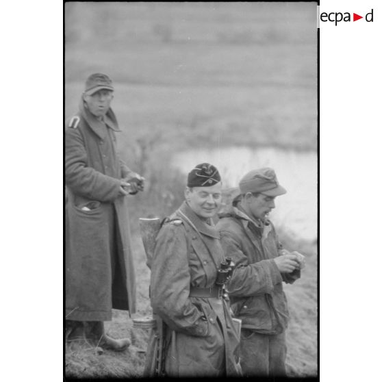 Deux Panzergrenadiers et un officier du Panzer Propagandakompanie 697.