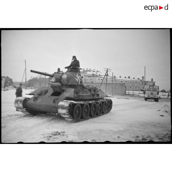 Dans une rue de Witebsk, un char soviétique T-34 (Beutepanzer) capturé. On remarque le nom du commandant "Hoppe" peint sur la tourelle du char.