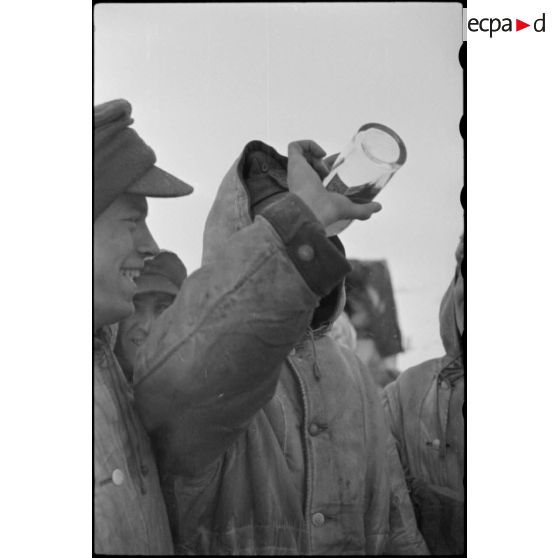 Des fantassins de la 4e division d'infanterie de l'armée de l'Air allemande (4. Luftwaffe Feld Division) partagent une bouteille.