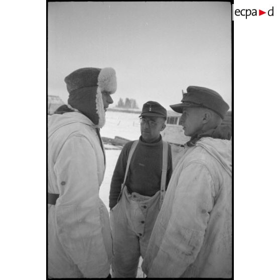 Le lieutenant de réserve (Oberleutnant der Reserve) Strehler discutant avec deux autres officiers du schwere Panzerjäger-Abteilung 519.