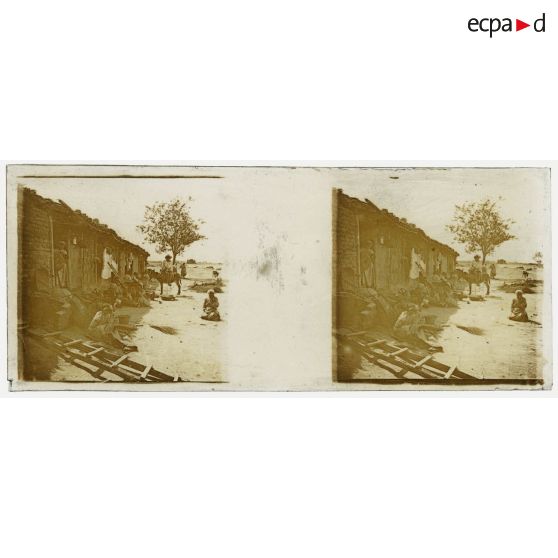 [Vie locale : population devant des maisons basses].<br>