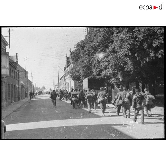 Rhe Feldy. [Un convoi de soldats dans une ville]. [Description en cours]