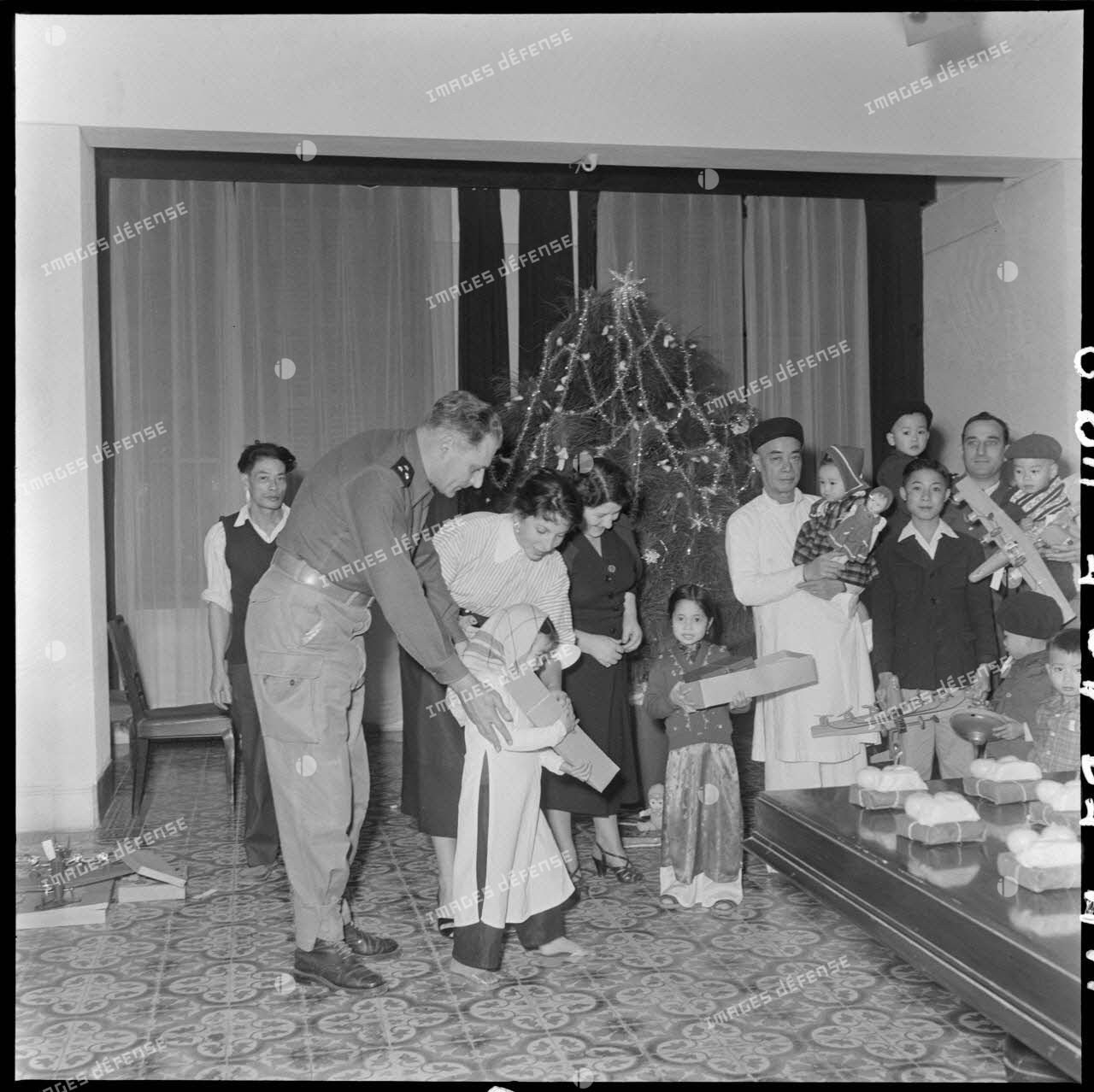 Le général Cogny, commandant en chef des FTNV (forces terrestres du Nord-Vietnam), sa fille et son épouse (sur sa gauche) lors d'une fête de Noël.