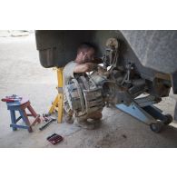 Le caporal Florian du 13e bataillon de chasseurs alpins (BCA) effectue la remise en état du système de roulage d'un véhicule de l'avant blindé (VAB) à Tombouctou, au Mali.