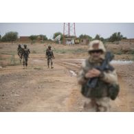 Des soldats nigériens sécurisent le périmètre de la reconnaissance menée par le lieutenant Robert des actions civilo-militaires (CIMIC) à Inatès, au Niger.