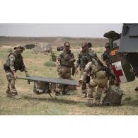 Une équipe médicale évacuent un soldat blessé depuis un véhicule de l'avant blindé sanitaire (VAB SAN) près d'Ayorou, au Niger.