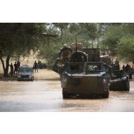 Des véhicules de l'avant blindés (VAB) franchissent une zone inondée entre Inatès et Ayorou, au Niger.