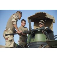 Des soldats du 7e bataillon de chasseurs alpins (BCA) montent une mitrailleuse Browning M2 de 12,7 mm à bord de leur véhicule de l'avant blindé (VAB) à Tillabéri, au Niger.