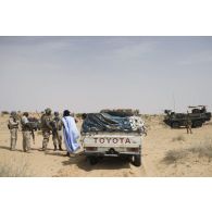 Des soldats maliens fouillent un pick-up suspect sous la protection des sapeurs du 2e régiment étranger de génie (REG) dans le secteur des monts Farach, au Mali.