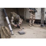 Un soldat photographie les indices trouvés lors de la fouille d'un garage par l'armée malienne à Tombouctou, au Mali.