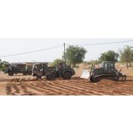 Une chargeuse-pelleteuse Terex TL 210 et bulldozer lourd PR724 du 25e régiment du génie de l'air (RGA) terrassent le sol à Niamey, au Niger.