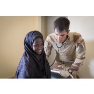 Le médecin des armées Victor ausculte une fillette asmathique à Tin Hama, au Mali.