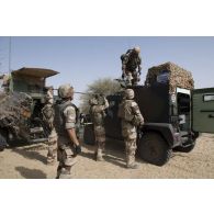 Des soldats du régiment de marche du Tchad (RMT) se préparent à désensabler leur véhicule dans la région de Bitagoungou, au Mali.