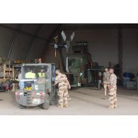 Des mécaniciens interviennent sur le rotor principal d'un hélicoptère Tigre EC-665 HAD pour sa remise en capacité opérationnelle à Niamey, au Niger.