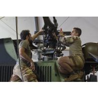 Des mécaniciens interviennent sur le rotor principal d'un hélicoptère Tigre EC-665 HAD pour sa remise en capacité opérationnelle à Niamey, au Niger.