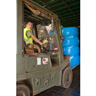 Déchargement de palettes de pneus de la soute d'un avion-cargo de transport Antonov 225 ukrainien par un engin de manutention transpalette OM du RTP (régiment du train parachutiste).