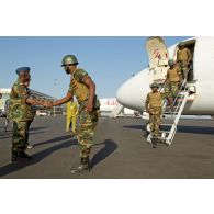 Le colonel togolais Bayakidéou Kpakpabia accueille d'une poignée de main des militaires de son contingent débarquant d'un avion civil sur l'aéroport de Bamako.
