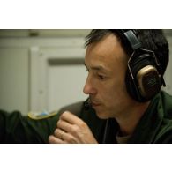 Portrait d'un adjudant opérateur de surveillance à son poste, lors d'une mission de contrôle aérien sur la Libye à bord d'un avion de détection Awacs.