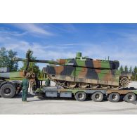 Des soldats guident le chargement d'un char Leclerc du 501e régiment de chars de combat (501e RCC) à bord d'un tracteur routier porte-chars de 50 tonnes (TR-PC 50) à Tapa, en Estonie.