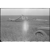 La carcasse d'un bombardier français Leo 45 avec sur la droite du cliché, la voiture Opel "Kapitän" du reporter.