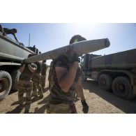 Des soldats déchargent une roquette prise aux terroristes depuis la benne d'un camion à Tessalit, au Mali.